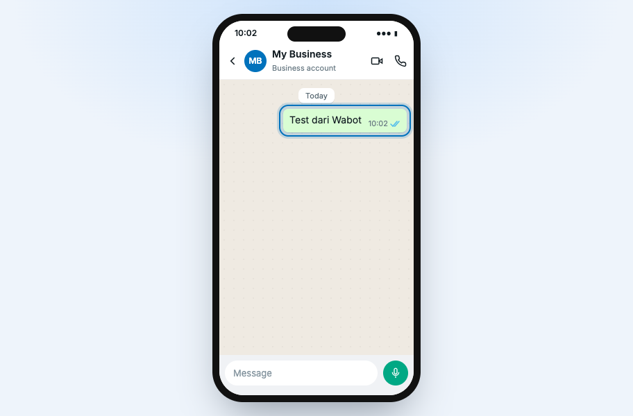 WhatsApp chat on a phone with Test dari Wabot sent to My Business